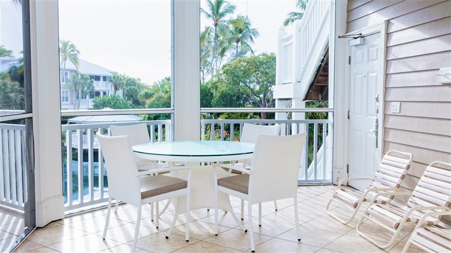 Dining area on a patio with a view of Sanibel.