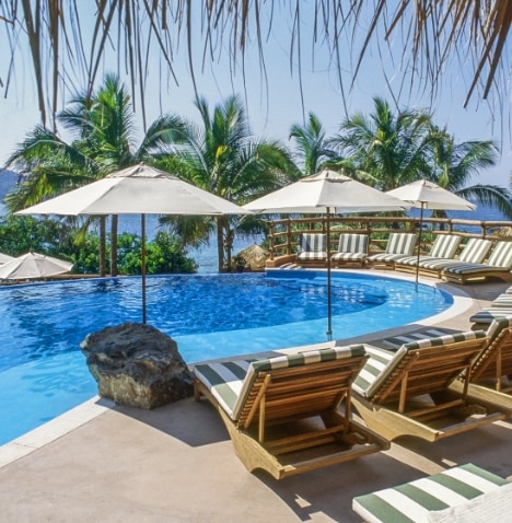 Poolside lounge chairs at Hilton Grand Vacations Club Zihuatanejo