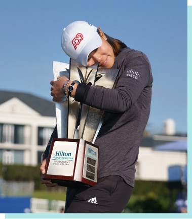 Golfer hugs trophy