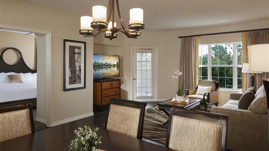 Dining room and living room at SeaWorld® Orlando, a Hilton Grand Vacations Club located in Orlando, Florida.
