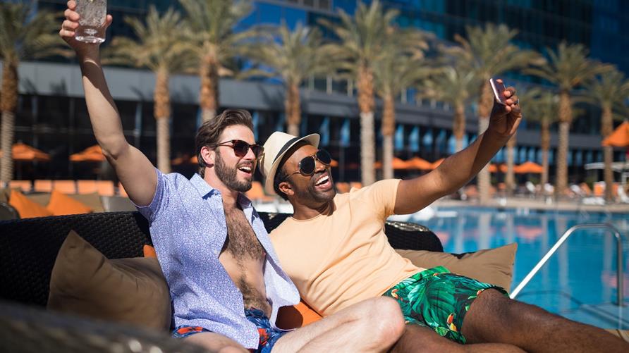 LBGTQ couple poolside selfie.