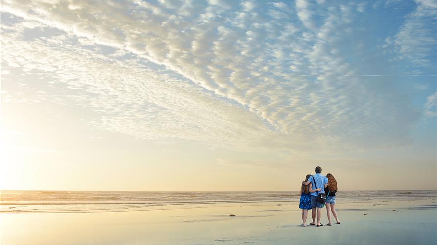 Family watching sunset on Florida Beach