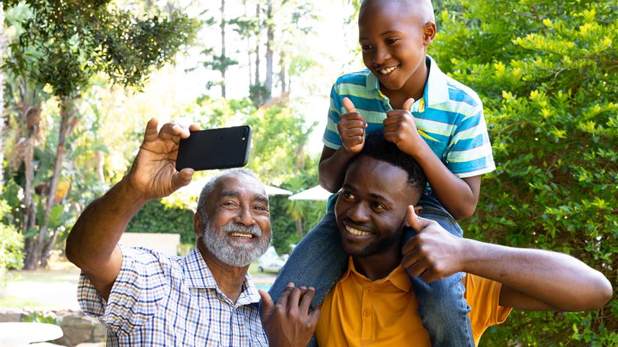 Dad, grandfather and son taking a selfie on a multigenerational vacation in Orlando, Florida.