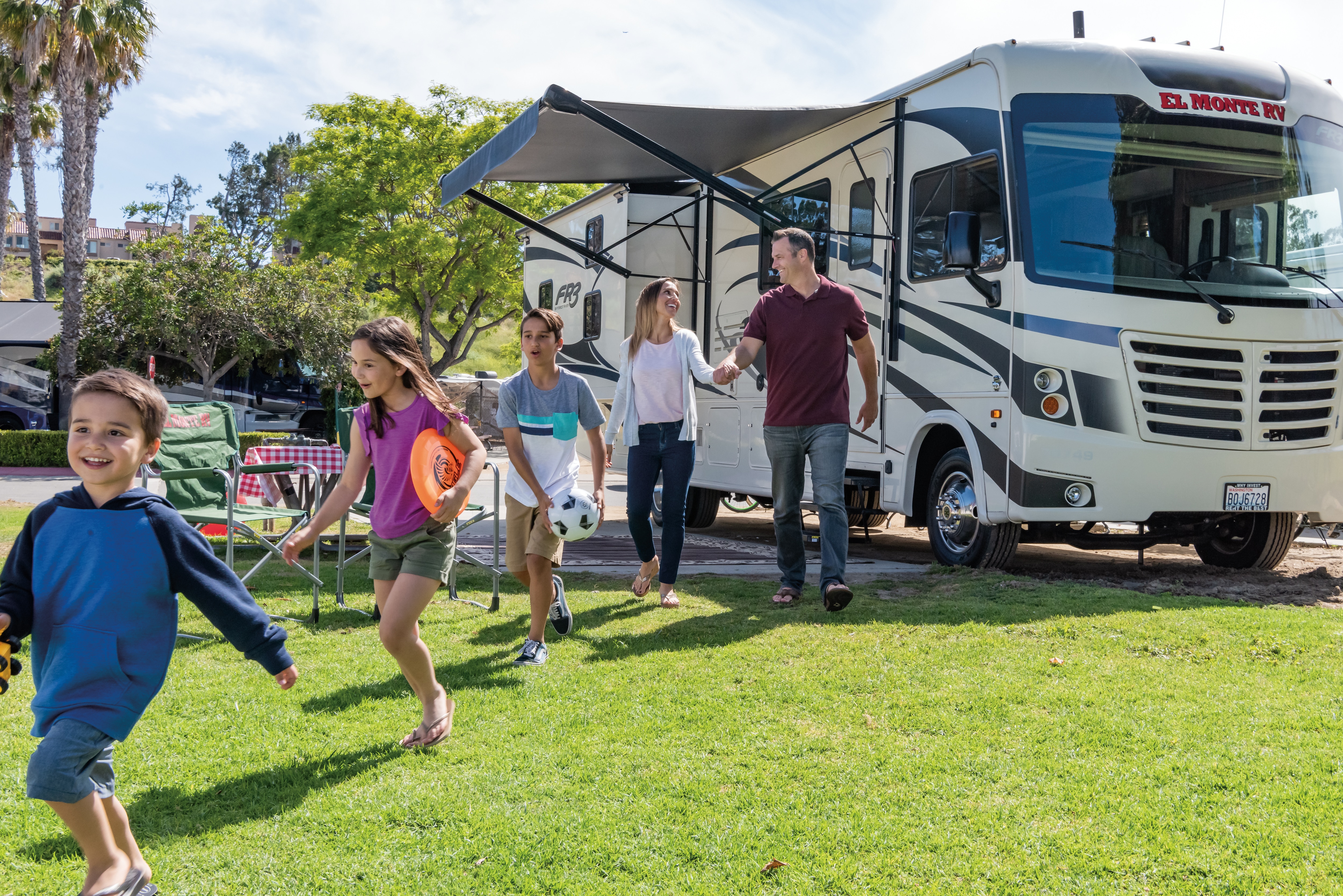Family outside El Monte RV in New Port Beach, California.