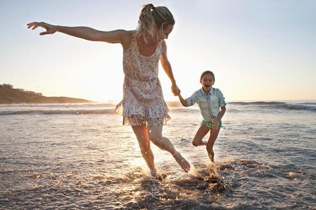 Mother and son running on beach