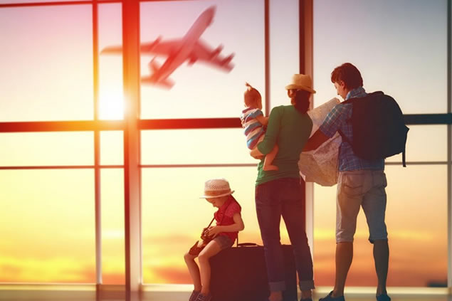 family watching plane take off at the airport