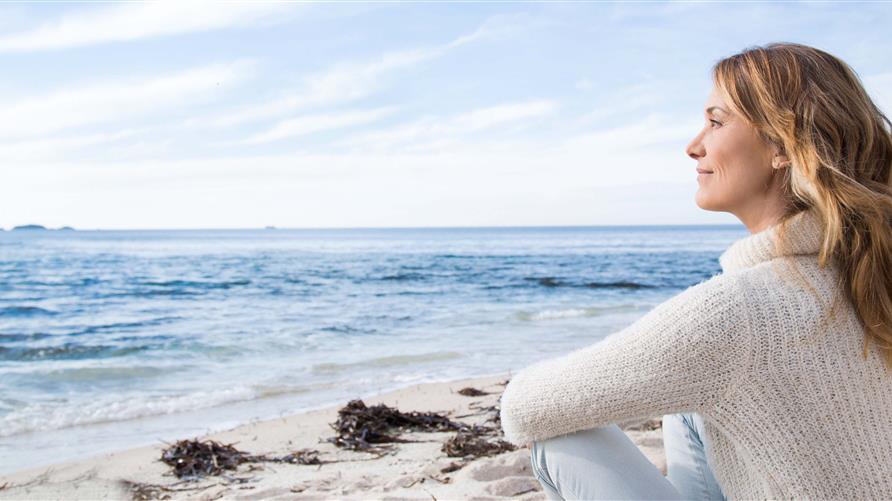 Young women looking into the ocean on the beach