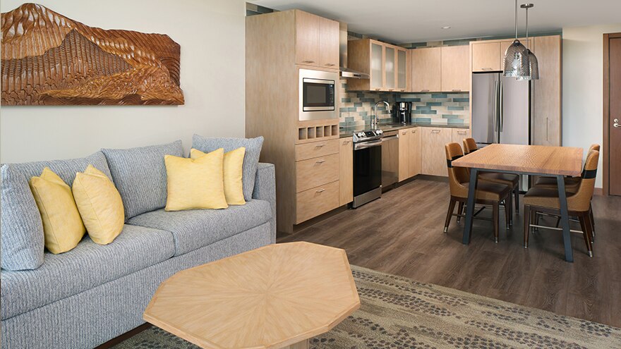 Living, dining and kitchen area in a suite at Maui Bay Villas, a Hilton Grand Vacations Club at Maui, Hawaii. 