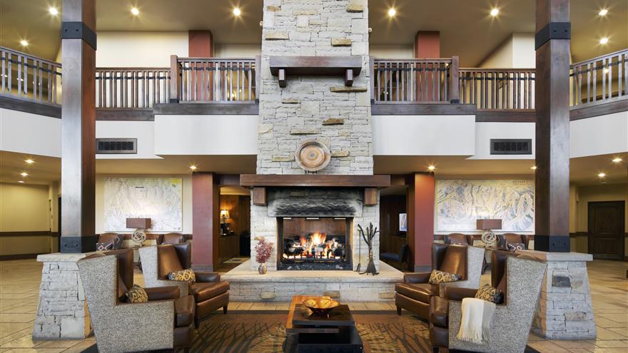 Lobby with fireplace at Sunrise Lodge, a Hilton Grand Vacations Club located in Park City, Utah. 